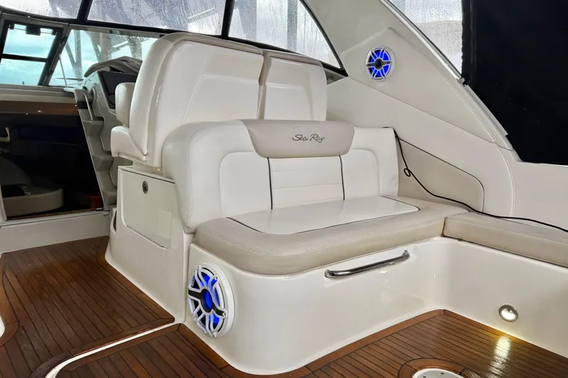 Finding Time Yacht Photos Pics Interior of 2011 Sea Ray 350 Sundancer with white seating and wood flooring.