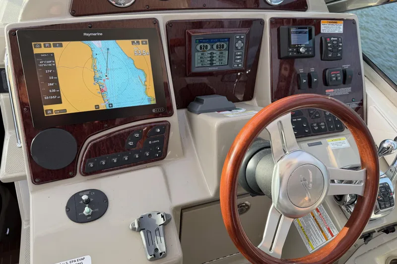 Finding Time Yacht Photos Pics Cockpit of 2011 Sea Ray 350 Sundancer with navigation system and wooden steering wheel.