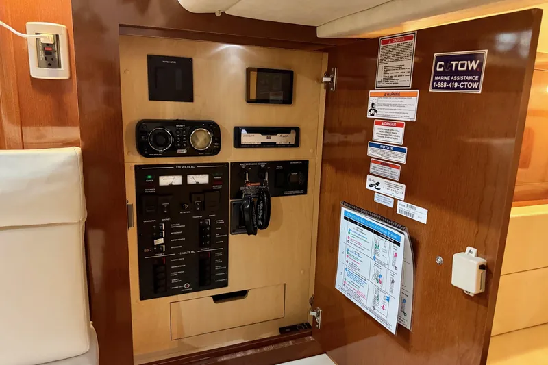 Finding Time Yacht Photos Pics 2011 Sea Ray 350 Sundancer control panel with various switches and safety notices.