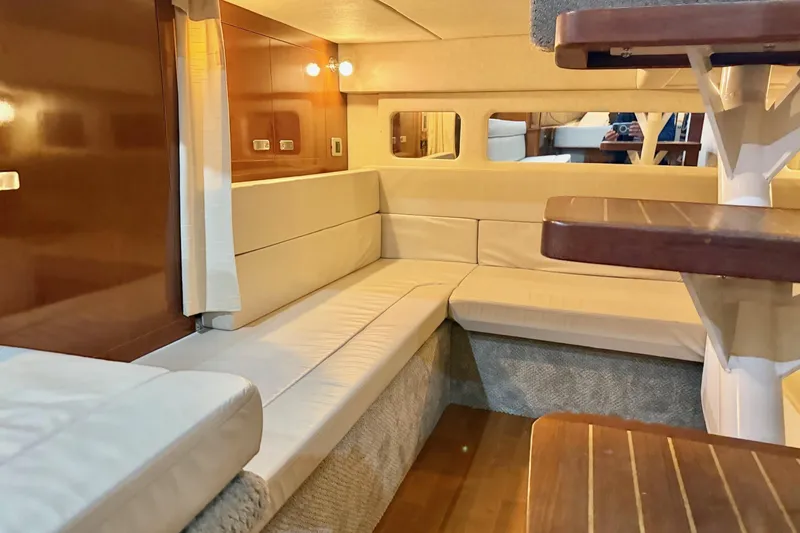 Finding Time Yacht Photos Pics Luxurious interior of 2011 Sea Ray 350 Sundancer yacht with plush seating and wooden accents.