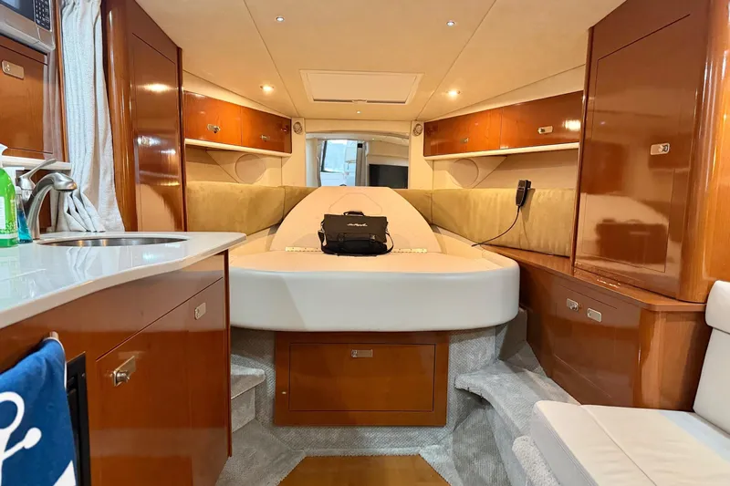 Finding Time Yacht Photos Pics Luxurious interior of 2011 Sea Ray 350 Sundancer yacht with wood cabinetry and cozy seating.