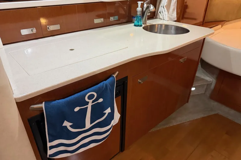 Finding Time Yacht Photos Pics 2011 Sea Ray 350 Sundancer interior with kitchenette, sink, and nautical-themed towel.