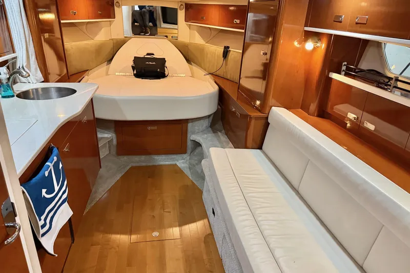 Finding Time Yacht Photos Pics Luxurious interior of 2011 Sea Ray 350 Sundancer yacht with cozy seating and kitchenette.