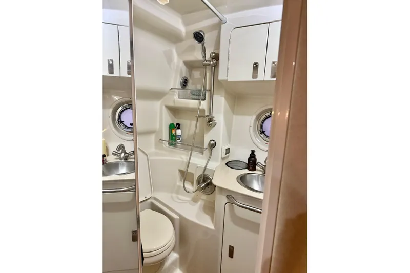 Finding Time Yacht Photos Pics 2011 Sea Ray 350 Sundancer bathroom with shower, sink, and storage cabinets.