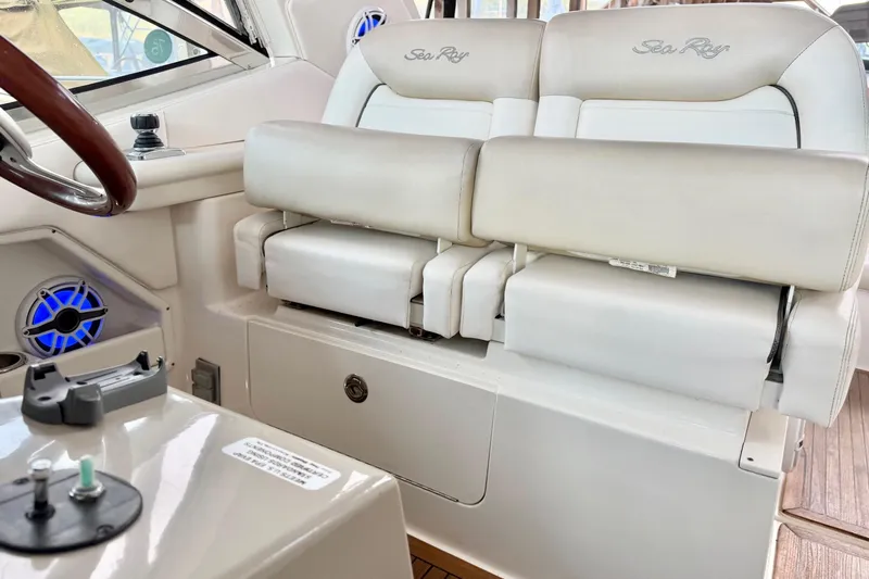 Finding Time Yacht Photos Pics Interior of 2011 Sea Ray 350 Sundancer with white leather seating and steering wheel.