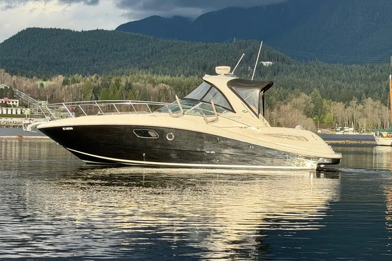 Finding Time Yacht Photos Pics 2011 Sea Ray 350 Sundancer yacht on calm water with scenic mountain backdrop.