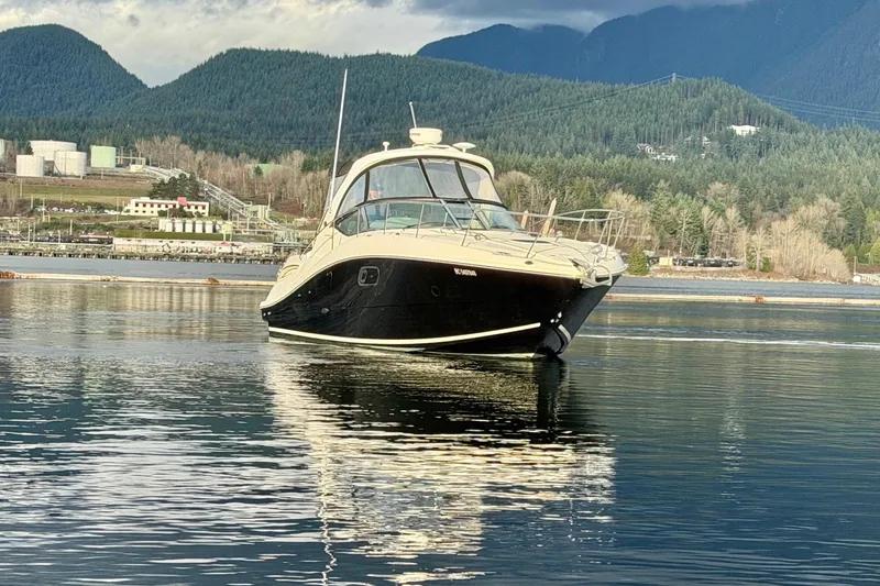 Finding Time Yacht Photos Pics 2011 Sea Ray 350 Sundancer yacht on calm water with scenic mountain backdrop.
