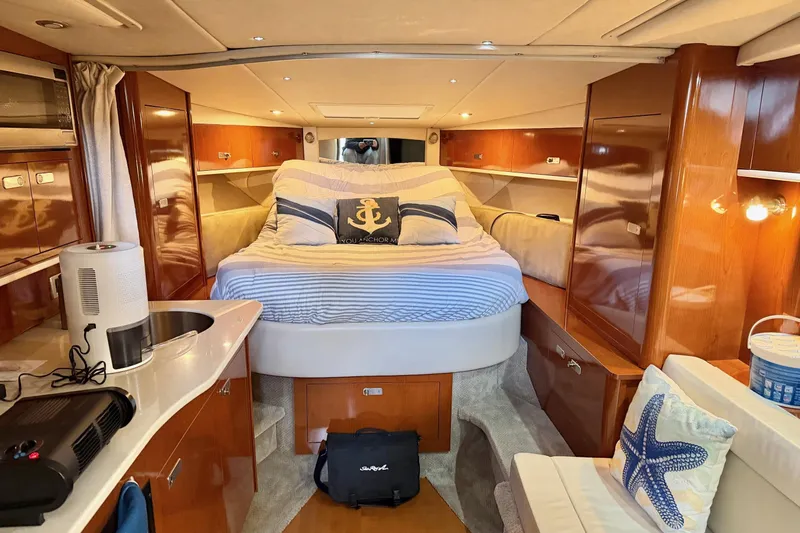 Finding Time Yacht Photos Pics Luxurious interior of 2011 Sea Ray Sundancer 350 yacht with cozy bed and modern amenities.
