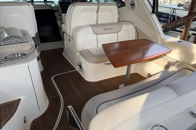 Finding Time Yacht Photos Pics Interior of 2011 Sea Ray Sundancer 350 yacht with seating and wooden table.