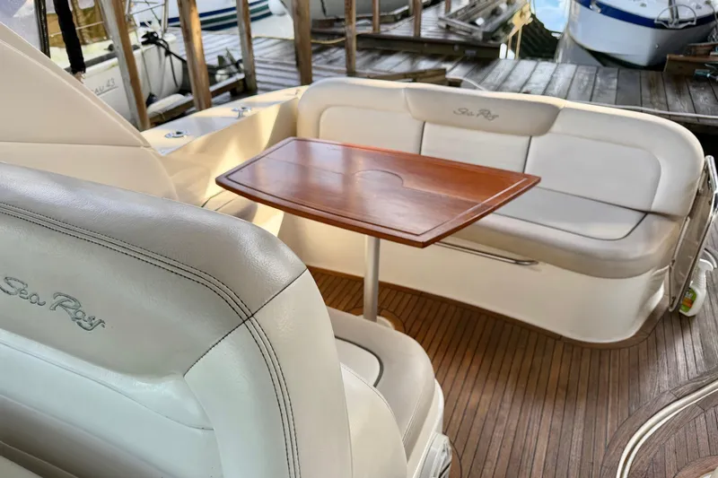 Finding Time Yacht Photos Pics Luxurious 2011 Sea Ray Sundancer 350 interior with elegant seating and wooden table.