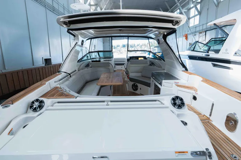  Yacht Photos Pics 2021 Sea Ray SLX 350 luxury boat interior with seating and wooden table.