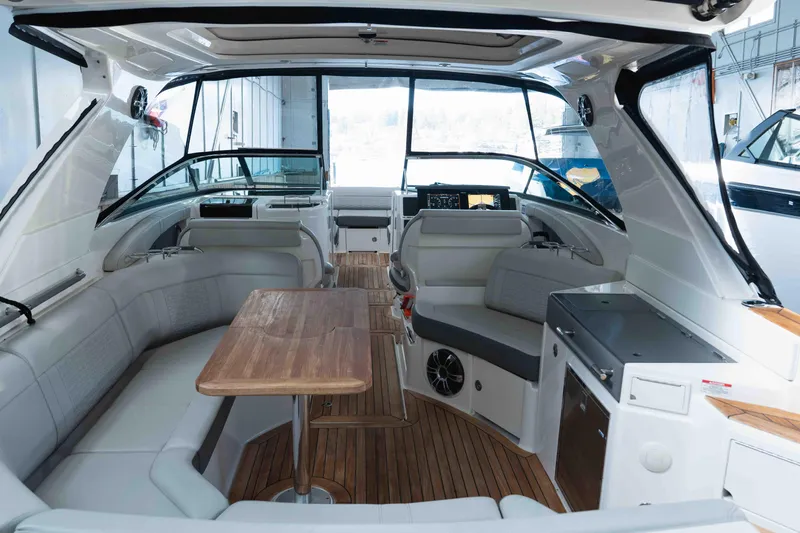  Yacht Photos Pics Luxurious 2021 Sea Ray SLX 350 boat interior with elegant seating and wooden table.