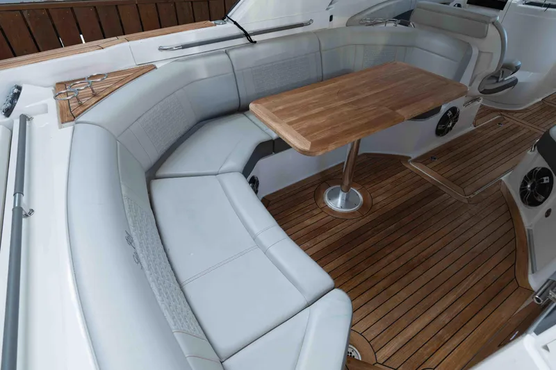  Yacht Photos Pics 2021 Sea Ray SLX 350 boat interior with elegant seating and wooden table.