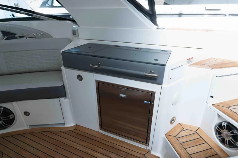  Yacht Photos Pics Luxurious interior of 2021 Sea Ray SLX 350 boat with sleek cabinetry and wood flooring.