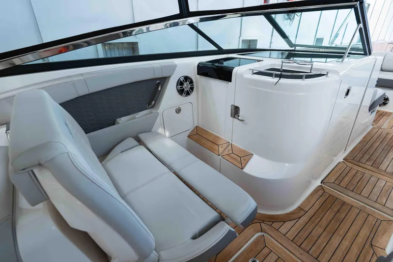  Yacht Photos Pics 2021 Sea Ray SLX 350 interior with sleek seating and wooden flooring.