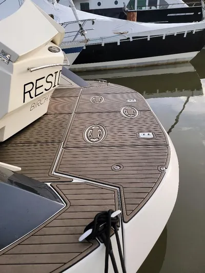  Yacht Photos Pics 2009 Marquis SC yacht with teak deck, docked in marina.