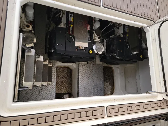  Yacht Photos Pics Engine compartment of a 2009 Marquis SC boat, showing dual engines and access steps.