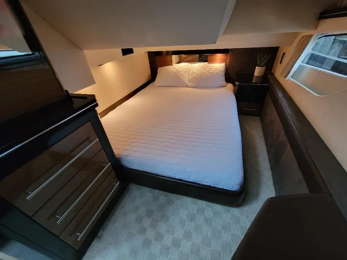  Yacht Photos Pics Luxurious bedroom interior of 2009 Marquis SC yacht with modern furnishings.