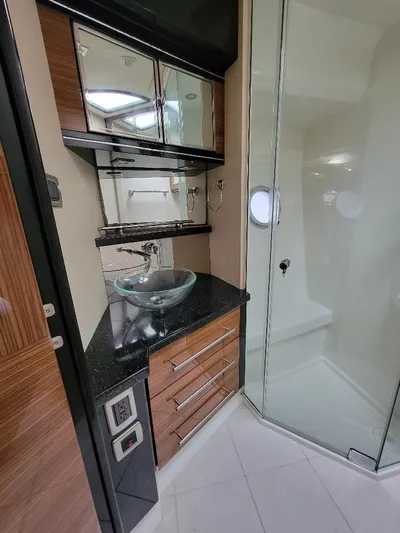  Yacht Photos Pics Luxurious 2009 Marquis SC bathroom with glass shower, modern sink, and wooden cabinetry.