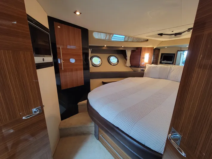 Yacht Photos Pics Luxurious 2009 Marquis SC yacht bedroom with elegant wood finishes and round windows.