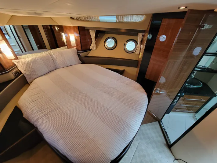  Yacht Photos Pics Luxurious 2009 Marquis SC yacht bedroom with round bed and porthole windows.