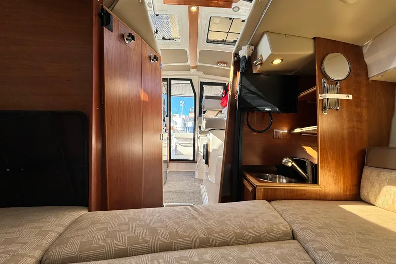  Yacht Photos Pics Interior of 2024 Cutwater C-248 Coupe, featuring cozy seating and compact kitchenette.