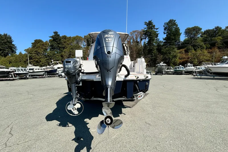  Yacht Photos Pics 2024 Cutwater C-248 Coupe with dual outboard engines in a boatyard setting.