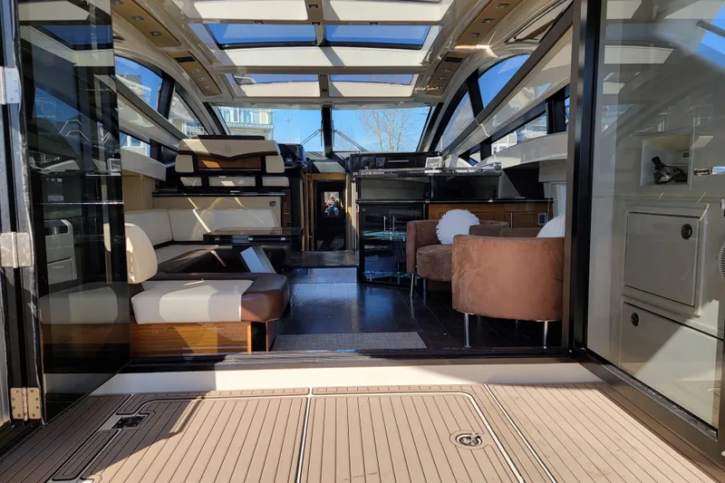 Yacht Photos Pics Luxurious interior of a 2009 Marquis SC yacht, featuring modern seating and expansive windows.