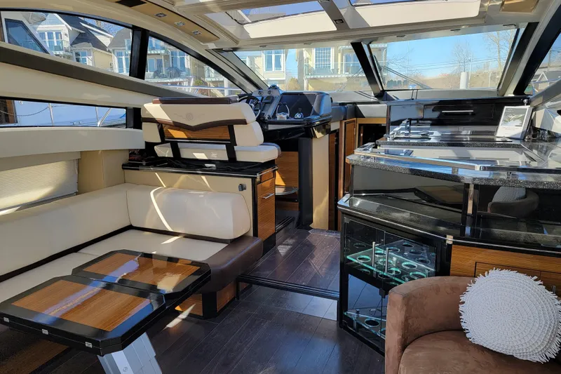  Yacht Photos Pics Luxurious interior of a 2009 Marquis SC yacht with modern seating and sleek design.