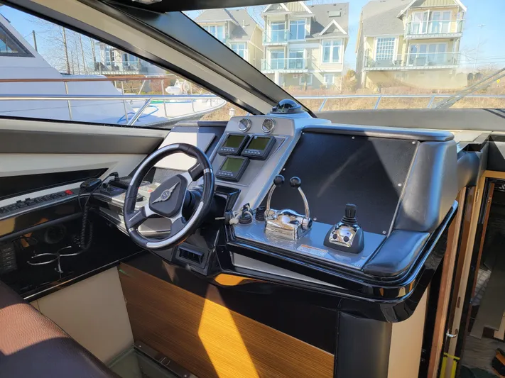  Yacht Photos Pics Interior of 2009 Marquis SC yacht with modern steering and control panel.