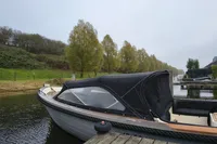 Custom Espevear 27 Open boat docked by a serene riverside, 2009 model.