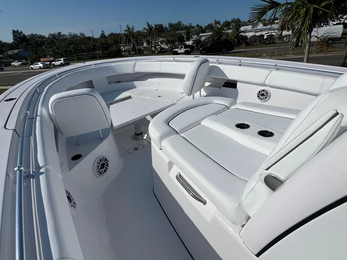  Yacht Photos Pics 2025 Sportsman 352 Open boat interior with white seating and table, showcasing luxury design.