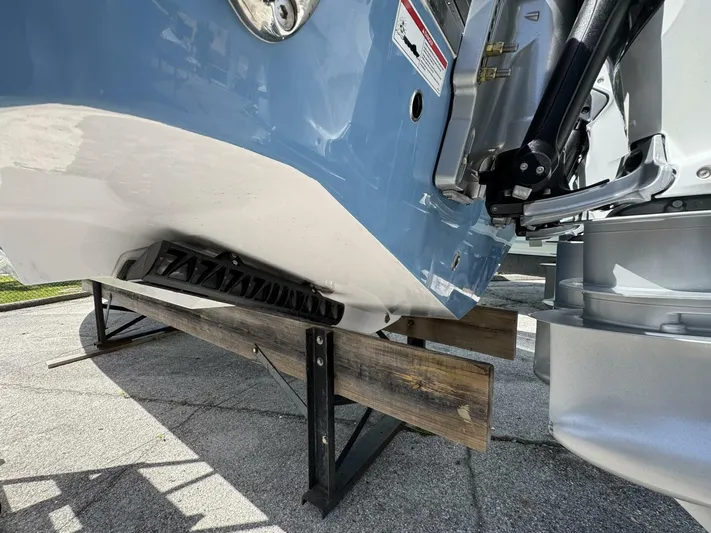  Yacht Photos Pics 2025 Sportsman 352 Open boat hull and engine detail on wooden support.