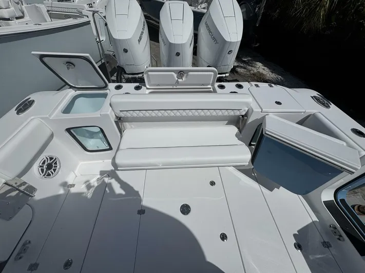  Yacht Photos Pics 2025 Sportsman 352 Open boat deck with seating and storage compartments.