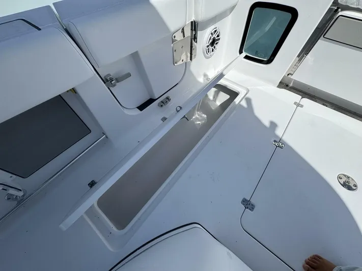  Yacht Photos Pics 2025 Sportsman 352 Open boat interior with open storage compartment and speaker.