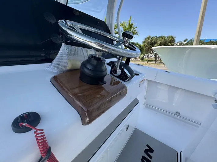  Yacht Photos Pics Steering wheel of 2025 Sportsman 352 Open boat, showcasing modern design and controls.