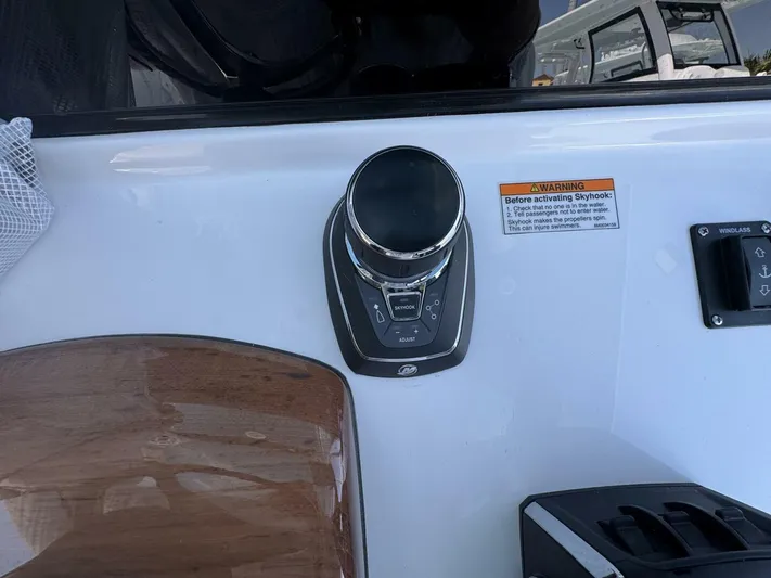  Yacht Photos Pics Control panel of 2025 Sportsman 352 Open boat with Skyhook feature and warning label.