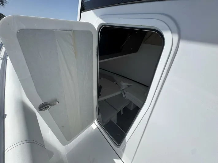  Yacht Photos Pics Open hatch on 2025 Sportsman 352 Open boat, revealing interior storage space.