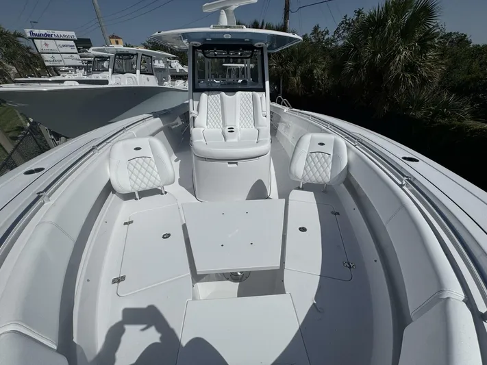  Yacht Photos Pics 2025 Sportsman 352 Open boat with white seating and table, docked at Thunder Marine.