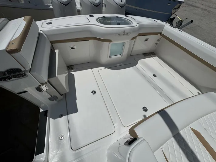  Yacht Photos Pics 2025 Regulator 35cc boat interior with white seating and storage compartments.