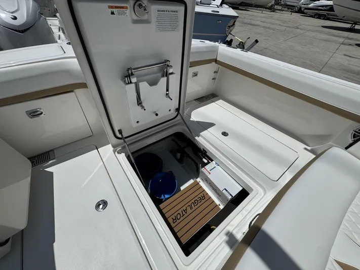  Yacht Photos Pics Open storage compartment on a 2025 Regulator 35cc boat, showcasing interior details.