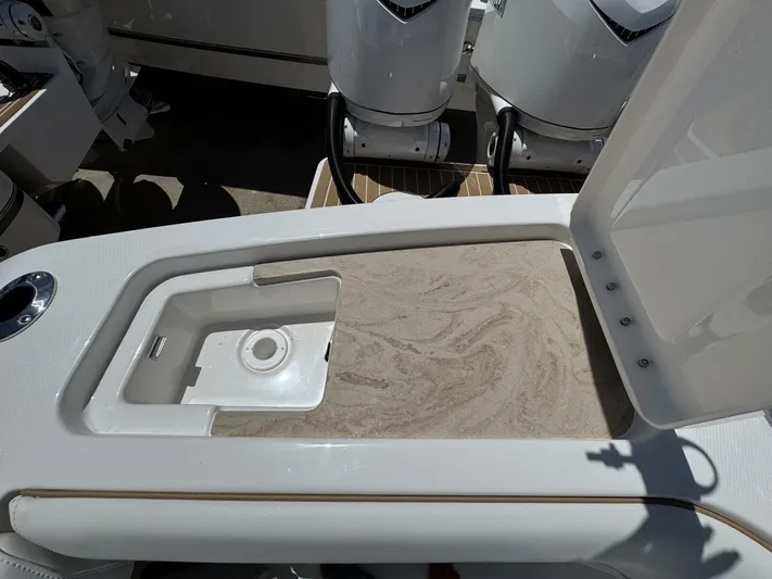  Yacht Photos Pics 2025 Regulator 35cc boat with open storage compartment and visible outboard motors.