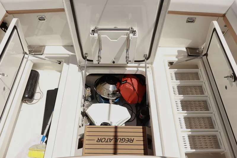  Yacht Photos Pics Open storage compartments on a 2025 Regulator 35cc boat, showcasing organized equipment.