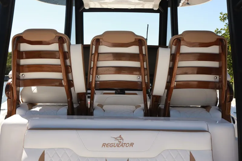  Yacht Photos Pics 2025 Regulator 35cc boat interior with elegant wooden seating and white upholstery.