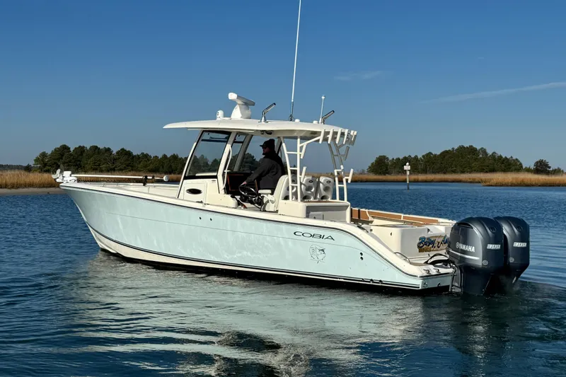 Betsey Ann Yacht Photos Pics 2015 Cobia 344 Center Console boat on calm water with dual Yamaha engines.