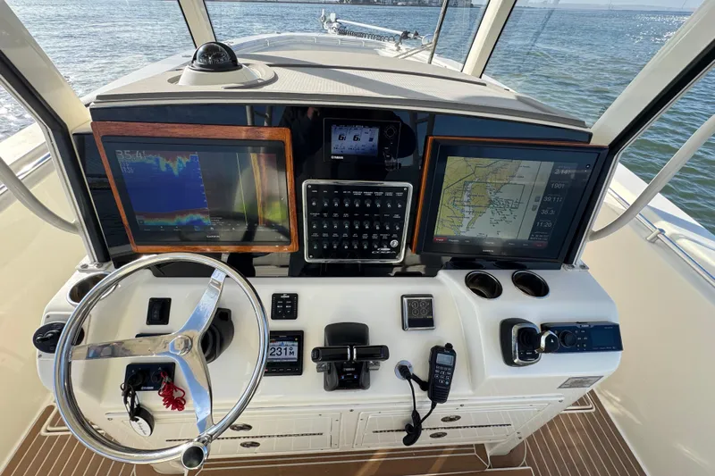 Betsey Ann Yacht Photos Pics 2015 Cobia 344 Center Console helm with navigation screens and controls.