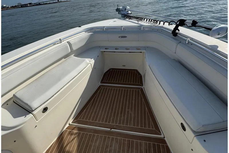 Betsey Ann Yacht Photos Pics 2015 Cobia 344 Center Console boat interior with cushioned seating and wooden flooring.