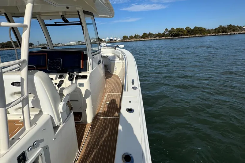 Betsey Ann Yacht Photos Pics 2015 Cobia 344 Center Console boat on calm water, featuring a sleek deck design.
