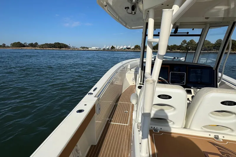 Betsey Ann Yacht Photos Pics 2015 Cobia 344 Center Console boat on calm water, clear sky, and distant shoreline.