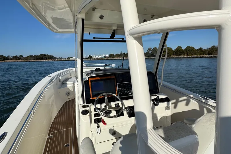 Betsey Ann Yacht Photos Pics 2015 Cobia 344 Center Console boat on water, featuring helm and navigation equipment.